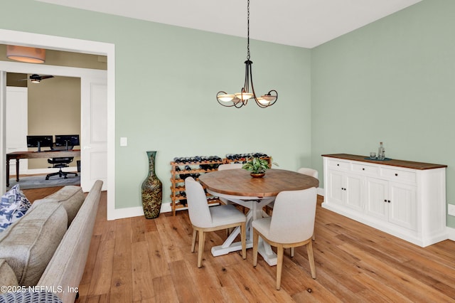 dining space featuring an inviting chandelier and light hardwood / wood-style floors