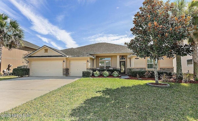 view of front of property with a garage and a front lawn