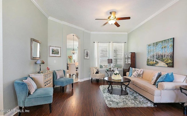 living room featuring ornamental molding, dark hardwood / wood-style floors, a textured ceiling, and ceiling fan