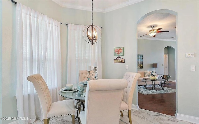 dining area featuring ceiling fan and ornamental molding