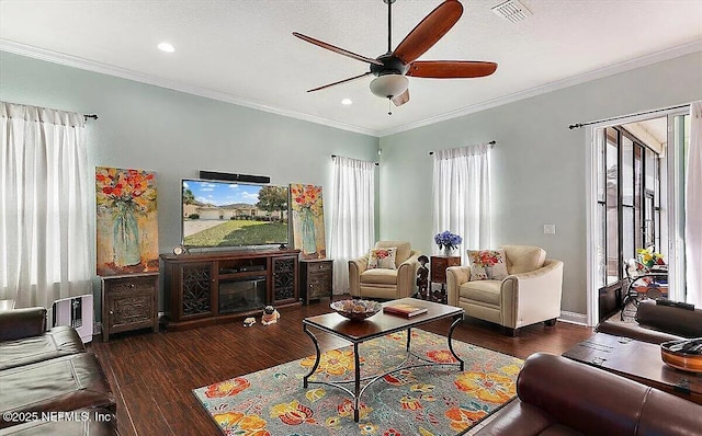 living room featuring ceiling fan, ornamental molding, dark hardwood / wood-style floors, and a textured ceiling