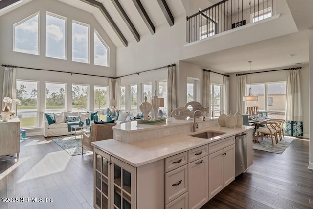 kitchen featuring sink, white cabinets, a high ceiling, pendant lighting, and dark hardwood / wood-style flooring