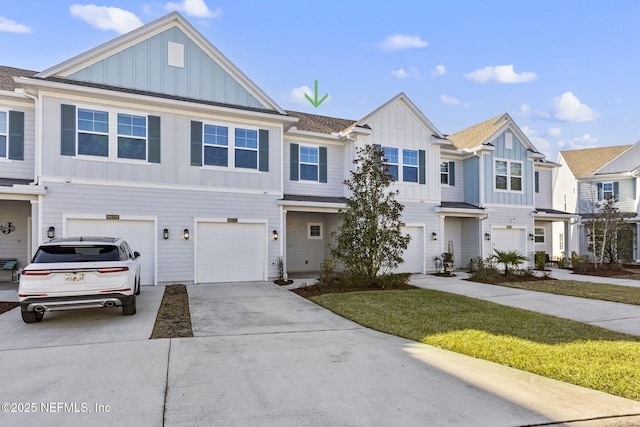 view of property featuring a garage and a front lawn