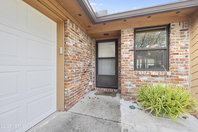 doorway to property with a garage