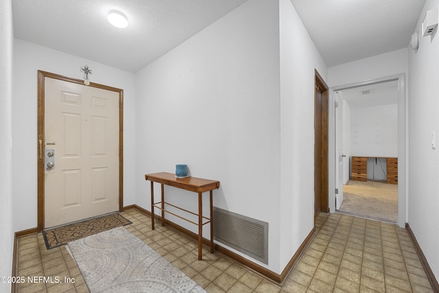 foyer with a textured ceiling