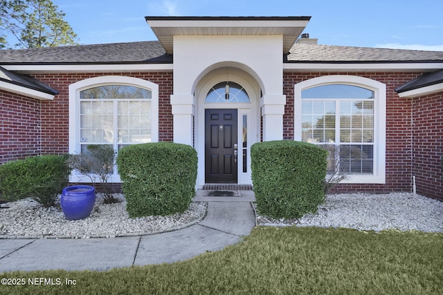 entrance to property featuring a yard