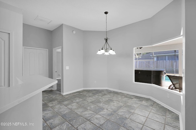 unfurnished dining area featuring a chandelier