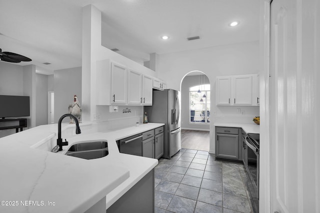 kitchen featuring sink, light tile patterned floors, gray cabinetry, and stainless steel appliances