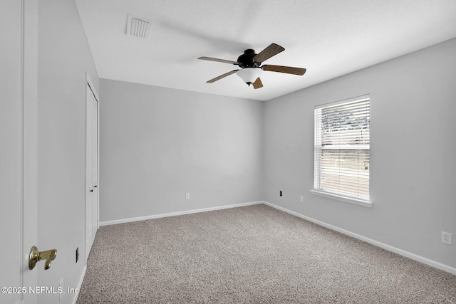 spare room featuring carpet floors and ceiling fan