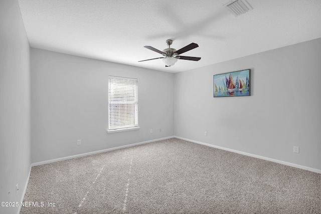 unfurnished room featuring ceiling fan and carpet flooring