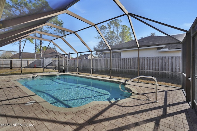 view of swimming pool featuring glass enclosure and a patio area