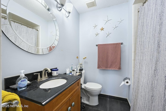 bathroom featuring vanity, tile patterned floors, toilet, and walk in shower