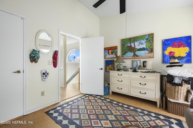 bedroom with light hardwood / wood-style flooring, high vaulted ceiling, and ceiling fan