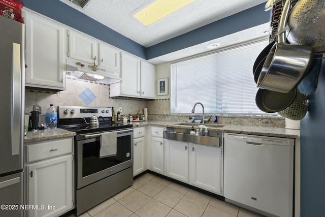 kitchen featuring stainless steel appliances, sink, and white cabinets