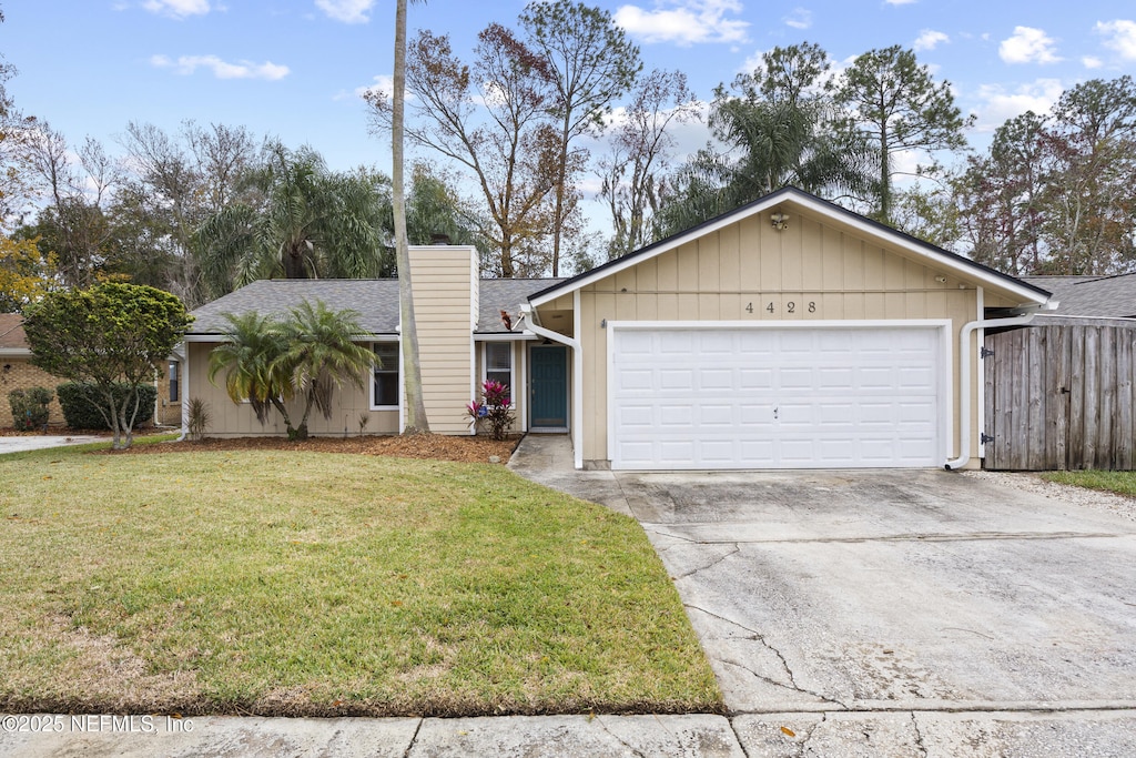 single story home featuring a garage and a front lawn