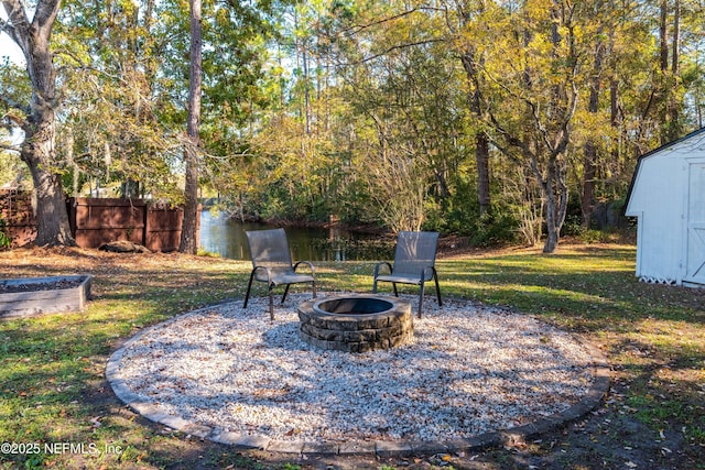 view of patio featuring an outdoor fire pit and a shed