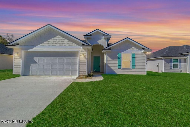 view of front of home featuring a garage and a lawn