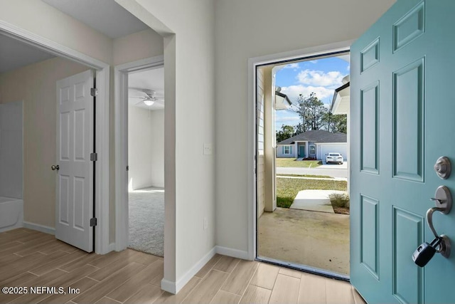 foyer entrance featuring ceiling fan