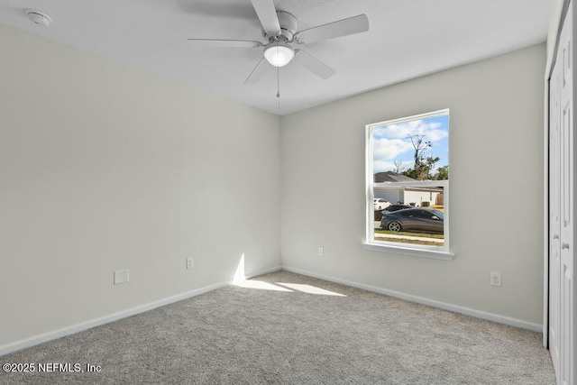 unfurnished room with ceiling fan and light carpet