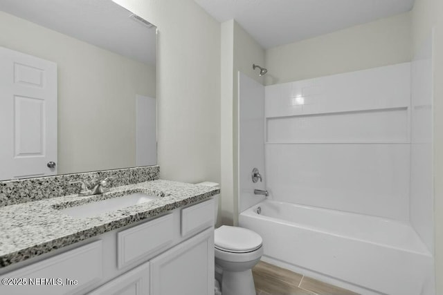 full bathroom with bathtub / shower combination, toilet, and vanity