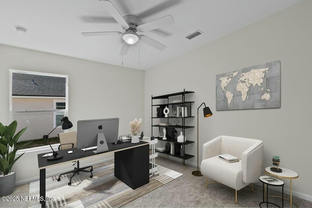 carpeted home office with ceiling fan