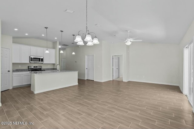 kitchen with white cabinetry, a kitchen island with sink, pendant lighting, stainless steel appliances, and lofted ceiling