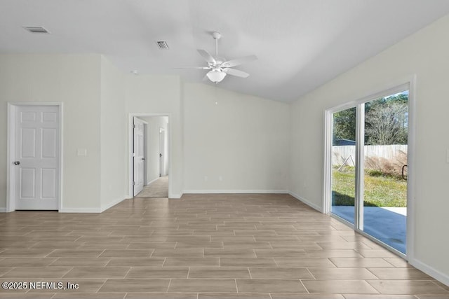 empty room with ceiling fan and vaulted ceiling