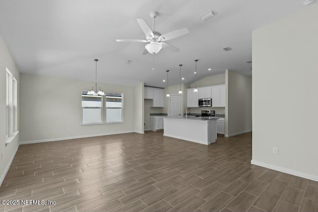 unfurnished living room with sink, ceiling fan with notable chandelier, and lofted ceiling