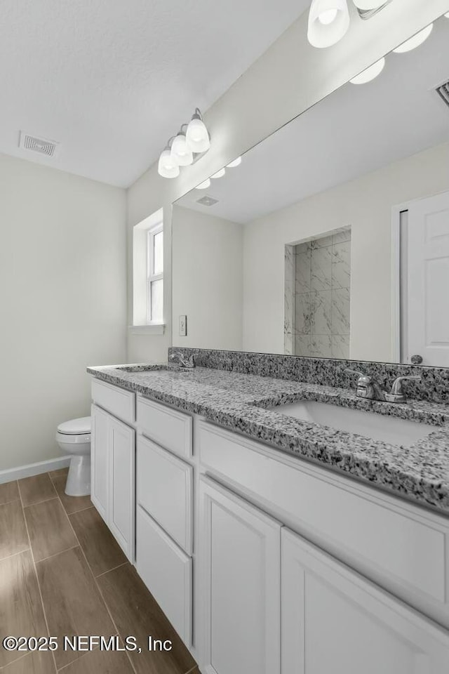 bathroom featuring vanity and toilet