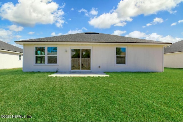 rear view of property with a lawn and a patio