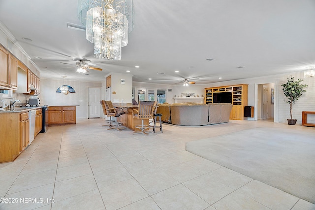 kitchen featuring sink, light tile patterned floors, ornamental molding, dishwasher, and ceiling fan with notable chandelier