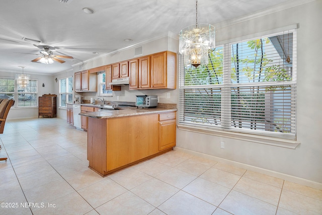 kitchen with ceiling fan with notable chandelier, pendant lighting, dishwasher, light tile patterned floors, and crown molding