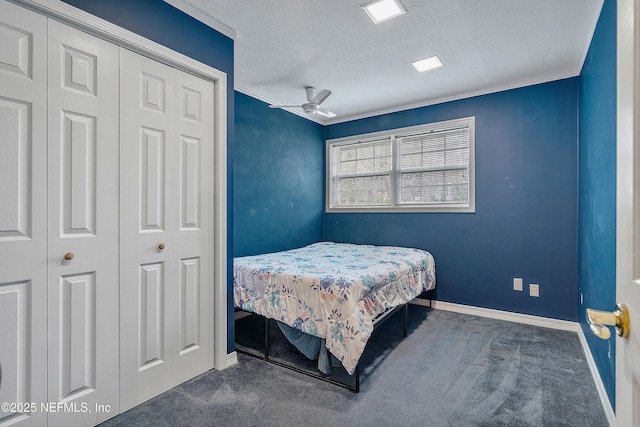 bedroom featuring ceiling fan, dark carpet, and a textured ceiling