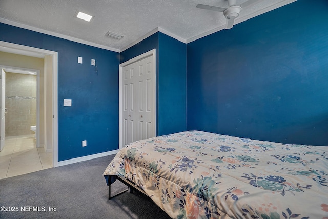 carpeted bedroom featuring ceiling fan, ornamental molding, a closet, and a textured ceiling