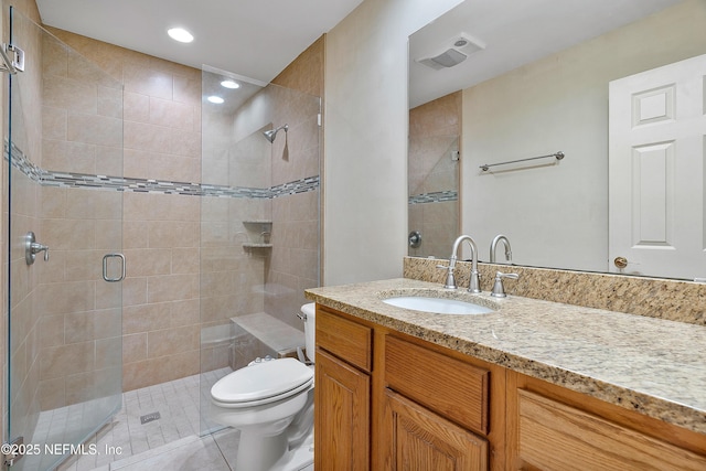 bathroom featuring tile patterned floors, toilet, an enclosed shower, and vanity