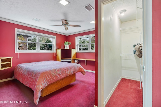 bedroom featuring crown molding, ceiling fan, carpet, and a textured ceiling