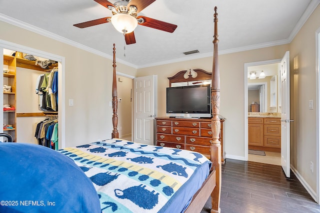 bedroom with ornamental molding, connected bathroom, ceiling fan, and a closet