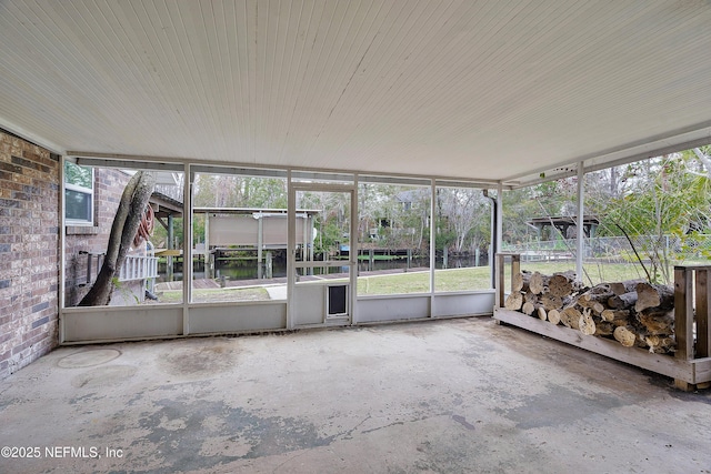 unfurnished sunroom featuring a water view