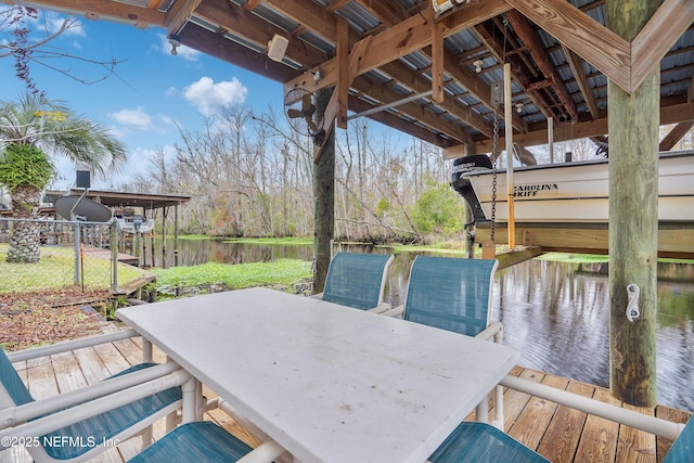 wooden deck with a water view and a boat dock