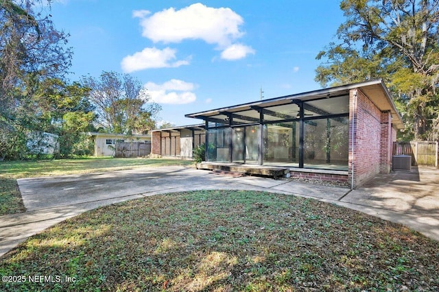 exterior space with a yard and a sunroom