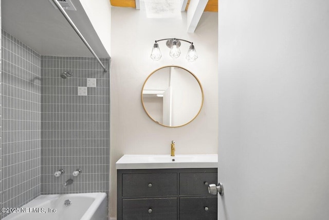 bathroom featuring vanity and tiled shower / bath combo