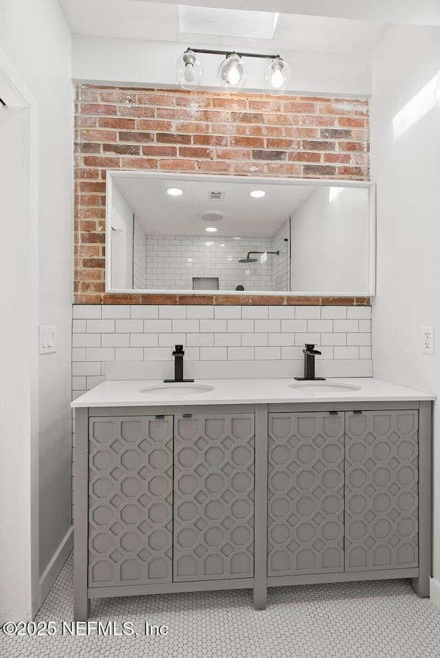 bathroom with tile walls, backsplash, vanity, and tile patterned flooring