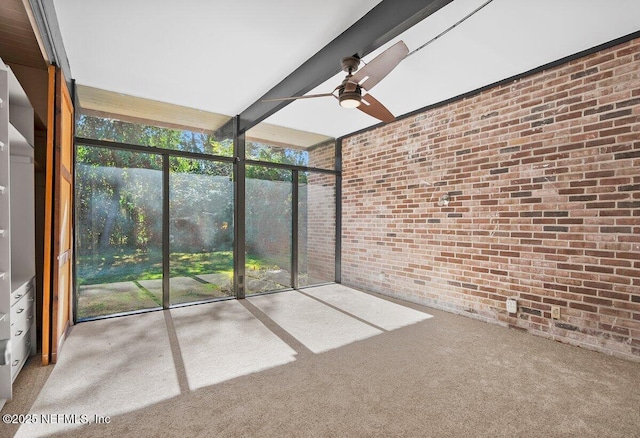 unfurnished sunroom featuring ceiling fan