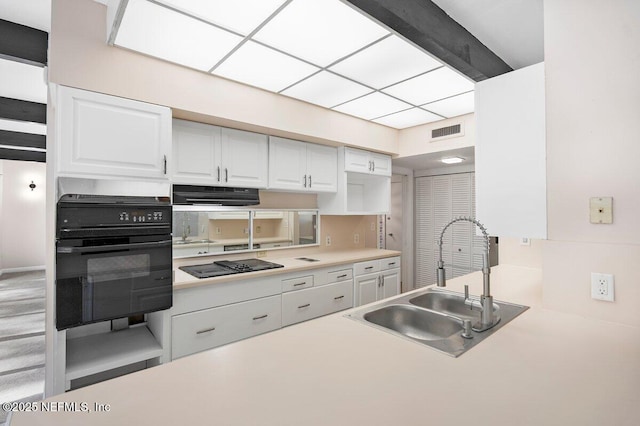 kitchen featuring white cabinetry, sink, extractor fan, and black appliances