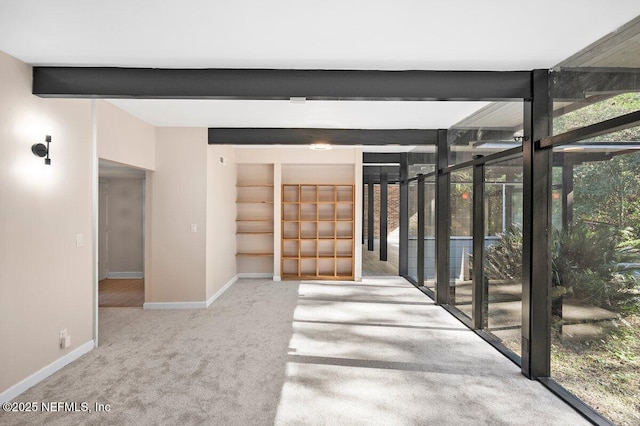 interior space with beamed ceiling and expansive windows