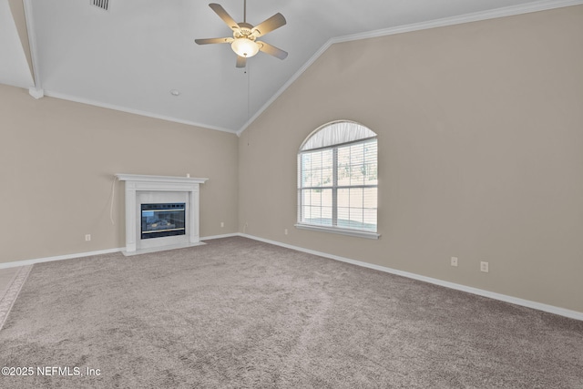 unfurnished living room with high vaulted ceiling, carpet floors, ornamental molding, ceiling fan, and a premium fireplace