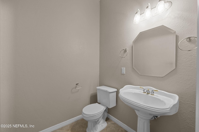 bathroom featuring toilet and tile patterned flooring