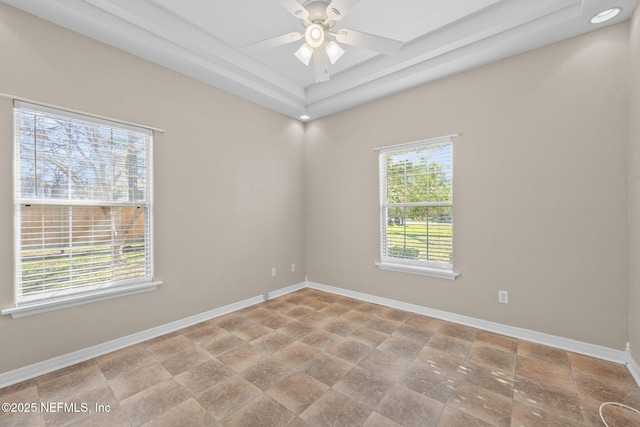 unfurnished room with a healthy amount of sunlight and ceiling fan