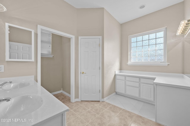 bathroom with tile patterned flooring and vanity