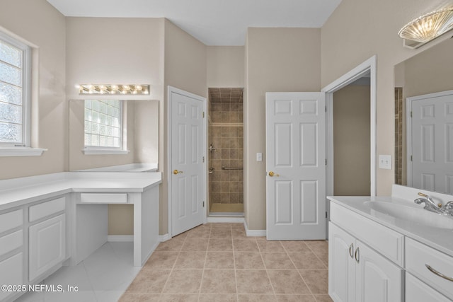 bathroom featuring tile patterned flooring, vanity, and a shower with door